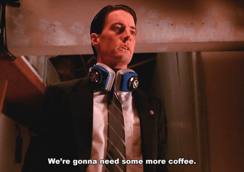 FBI Special Agent Dale Cooper from Twin Peaks, a white man in a dark suit with dark hair who has ear protection around his neck says "we're gonna need some more coffee"